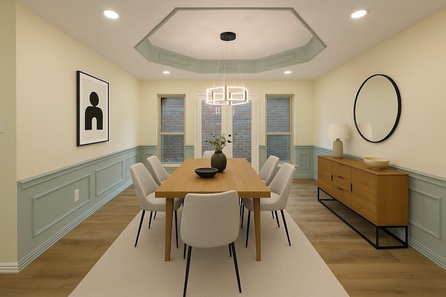 2524 Bear Haven Dr, Grapevine, TX 76051 - dining area featuring wainscoting, a decorative wall, a tray ceiling, light wood-style floors, and recessed lighting