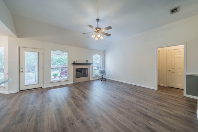 1405 Scotland Ave, Azle, TX 76020 - unfurnished living room featuring vaulted ceiling, ceiling fan, dark wood-style flooring, and a tiled fireplace
