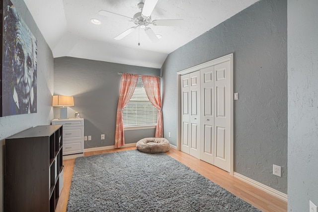 504 Rainforest Ln, Allen, TX 75013 - bedroom featuring a textured wall, light wood-style floors, a ceiling fan, a closet, and lofted ceiling