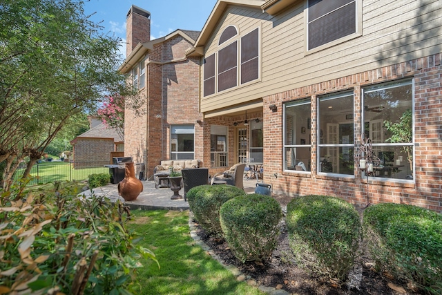 504 Rainforest Ln, Allen, TX 75013 - rear view of house featuring an outdoor living space, a patio area, brick siding, and a chimney