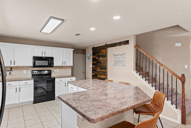 1524 Quails Nest Dr, Fort Worth, TX 76177 - kitchen featuring black appliances, decorative backsplash, light tile patterned flooring, a kitchen island, and a barn door