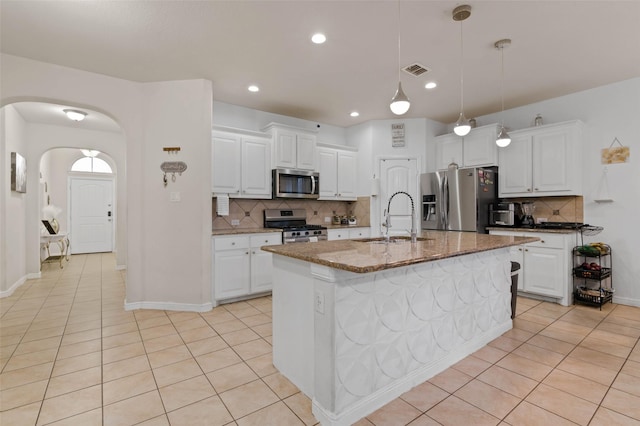 320 Grassland Dr, Denton, TX 76210 - kitchen featuring stainless steel appliances, tasteful backsplash, light tile patterned flooring, white cabinets, and recessed lighting