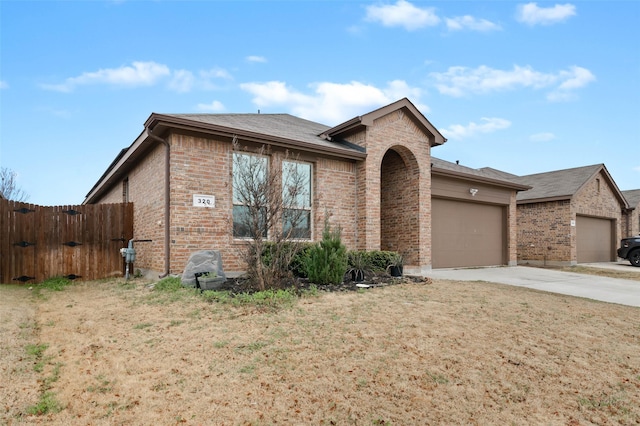 320 Grassland Dr, Denton, TX 76210 - ranch-style home with brick siding, concrete driveway, and a garage