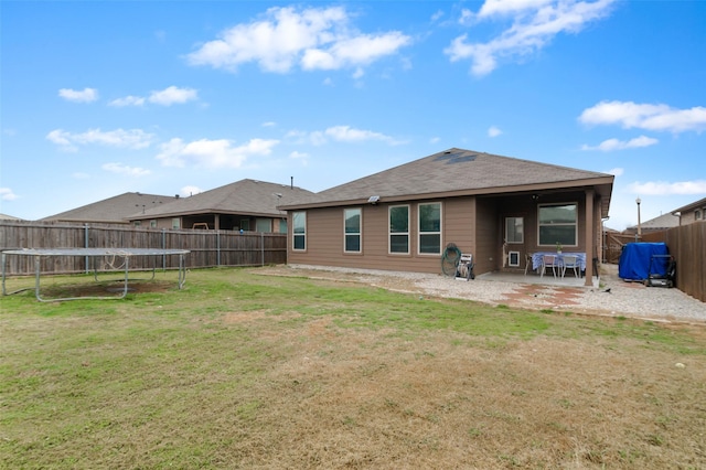 320 Grassland Dr, Denton, TX 76210 - rear view of property featuring a fenced backyard, a patio area, and a trampoline
