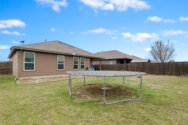 320 Grassland Dr, Denton, TX 76210 - back of property with a trampoline and a fenced backyard