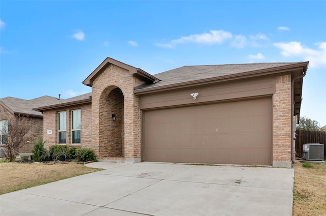 320 Grassland Dr, Denton, TX 76210 - view of front of home with brick siding, concrete driveway, and an attached garage