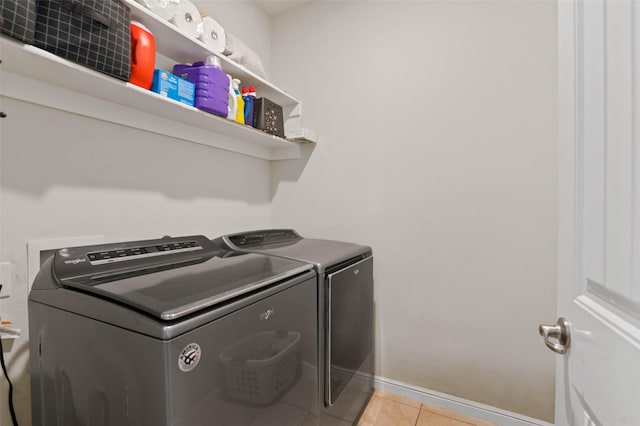 320 Grassland Dr, Denton, TX 76210 - laundry area with washer and clothes dryer and light tile patterned flooring