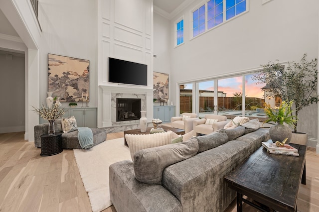 2009 Wheeler Dr, Southlake, TX 76092 - living area with crown molding, light wood finished floors, a towering ceiling, and a high end fireplace