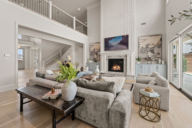 2009 Wheeler Dr, Southlake, TX 76092 - living room with a towering ceiling, light wood-style floors, stairway, and a fireplace