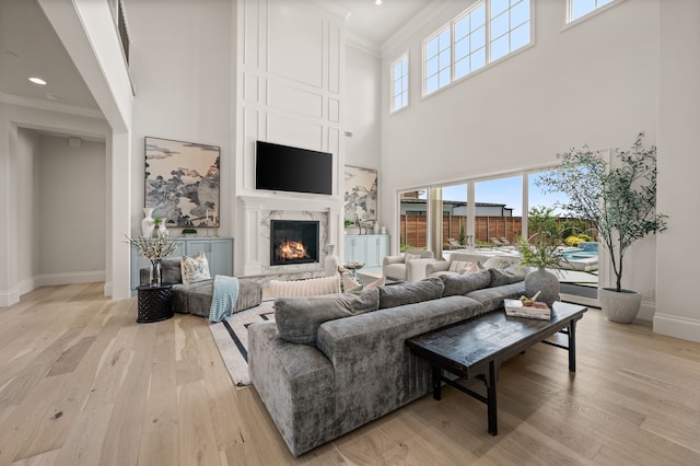 2009 Wheeler Dr, Southlake, TX 76092 - living area featuring crown molding, a towering ceiling, light wood-type flooring, a fireplace, and recessed lighting