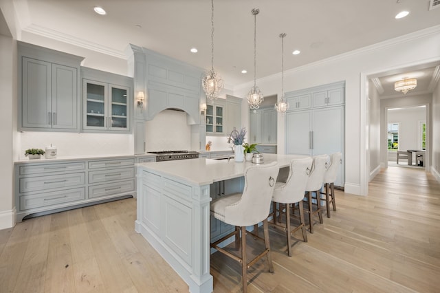 2009 Wheeler Dr, Southlake, TX 76092 - kitchen with a large island, light countertops, a kitchen bar, backsplash, and glass insert cabinets