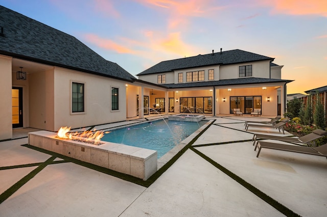 2009 Wheeler Dr, Southlake, TX 76092 - pool at dusk featuring a patio area, a fire pit, and a pool with connected hot tub
