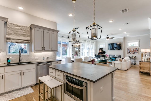441 Jones St, Grapevine, TX 76051 - kitchen with dark countertops, dishwasher, ceiling fan, a chandelier, and backsplash