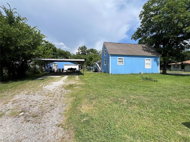 603 E Thomas St, Sherman, TX 75090 - view of green lawn with driveway and a detached carport