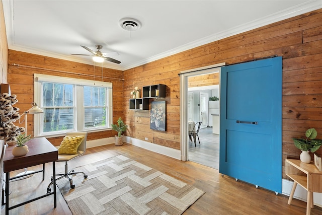 1000 W Hickory St, Denton, TX 76201 - home office with a ceiling fan, crown molding, wood walls, and wood finished floors