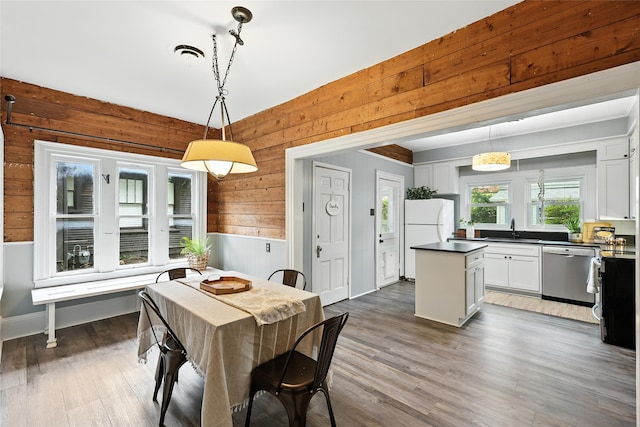 1000 W Hickory St, Denton, TX 76201 - dining area featuring wooden walls, wood finished floors, and wainscoting