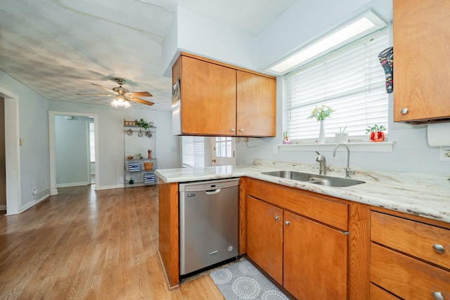 514 Fairview Dr, Richardson, TX 75081 - kitchen featuring stainless steel dishwasher, light wood-type flooring, brown cabinetry, a ceiling fan, and light stone countertops