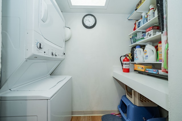 514 Fairview Dr, Richardson, TX 75081 - laundry area featuring estacked washer and dryer, light wood-style flooring, and a skylight