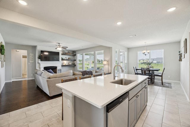 1001 Boulder Rd, Weatherford, TX 76085 - kitchen featuring stainless steel dishwasher, light tile patterned flooring, light countertops, plenty of natural light, and recessed lighting