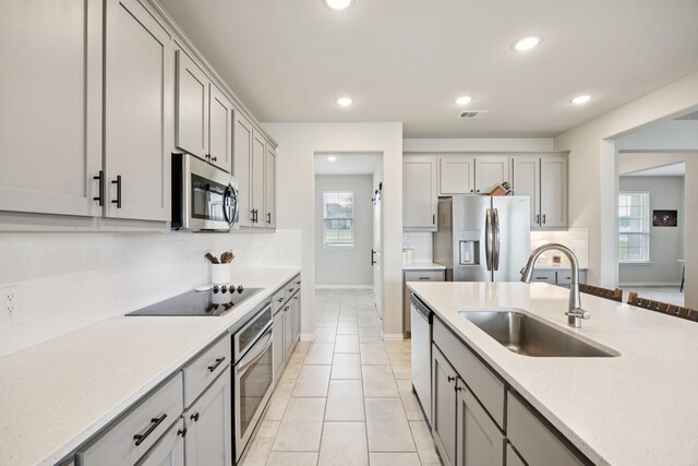 1001 Boulder Rd, Weatherford, TX 76085 - kitchen featuring stainless steel appliances, gray cabinets, recessed lighting, and plenty of natural light