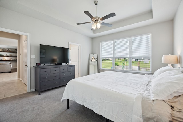1001 Boulder Rd, Weatherford, TX 76085 - bedroom with a raised ceiling, a ceiling fan, and light carpet