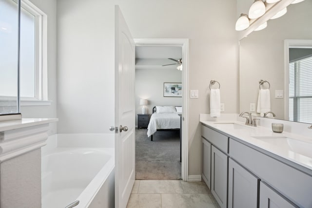 1001 Boulder Rd, Weatherford, TX 76085 - bathroom featuring ensuite bathroom, double vanity, a bath, a ceiling fan, and tile patterned floors