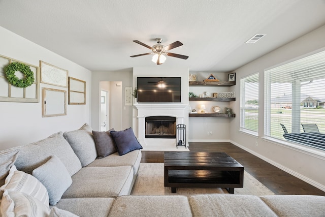 1001 Boulder Rd, Weatherford, TX 76085 - living room with a ceiling fan, a fireplace with flush hearth, and dark wood-style flooring