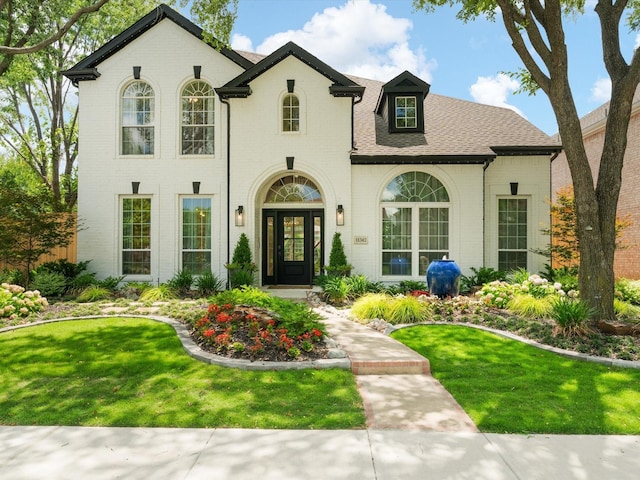11342 Raveneaux Dr, Frisco, TX 75033 - french provincial home featuring brick siding, a front yard, and a shingled roof