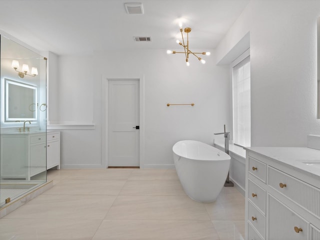 11342 Raveneaux Dr, Frisco, TX 75033 - full bath featuring a chandelier, vanity, a freestanding tub, and tile patterned floors