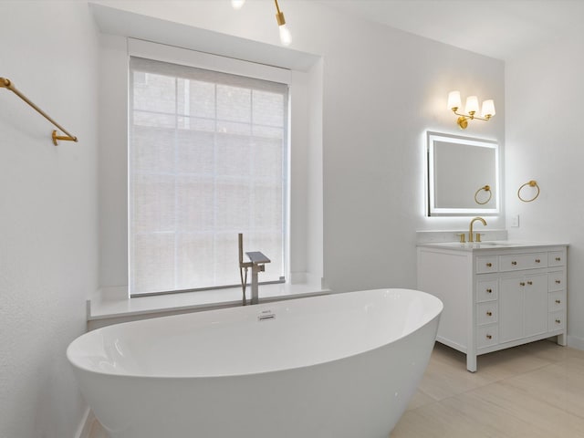 11342 Raveneaux Dr, Frisco, TX 75033 - bathroom with vanity, a freestanding tub, and tile patterned floors