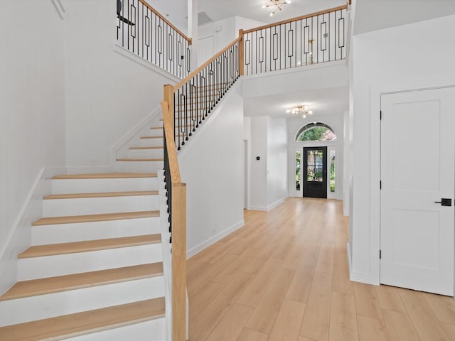 11342 Raveneaux Dr, Frisco, TX 75033 - entrance foyer with a high ceiling, stairway, and wood finished floors