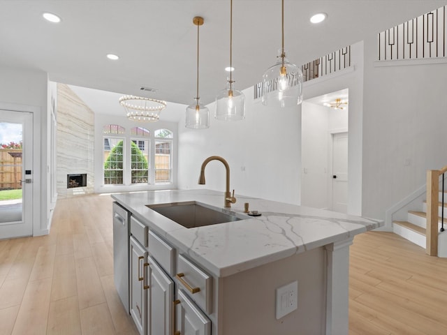 11342 Raveneaux Dr, Frisco, TX 75033 - kitchen featuring stainless steel dishwasher, open floor plan, light wood-type flooring, a center island with sink, and recessed lighting