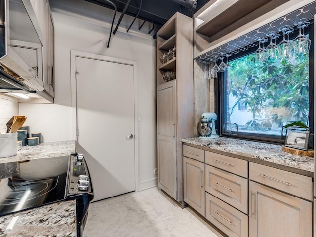 3110 Thomas Ave Unit 101, Dallas, TX 75204 - kitchen with black electric range, light stone counters, concrete flooring, and open shelves