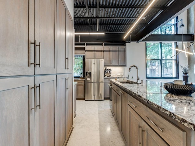 3110 Thomas Ave Unit 101, Dallas, TX 75204 - kitchen featuring stainless steel fridge, light stone countertops, and plenty of natural light