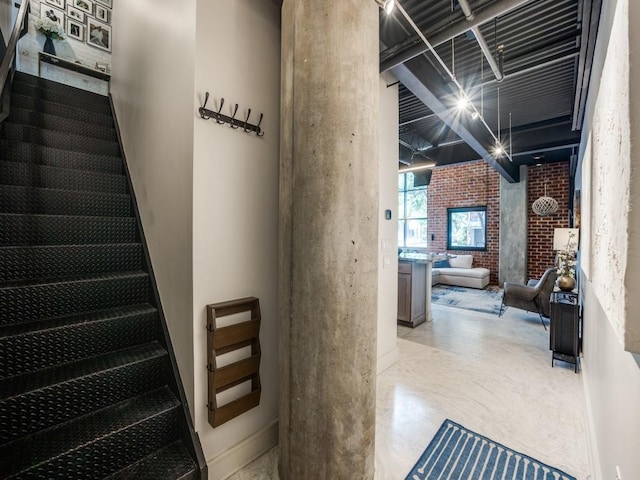 3110 Thomas Ave Unit 101, Dallas, TX 75204 - staircase featuring brick wall and ornate columns