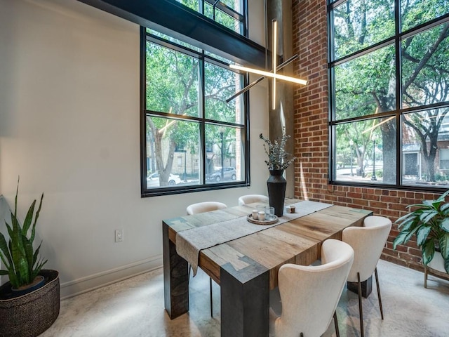 3110 Thomas Ave Unit 101, Dallas, TX 75204 - dining area with brick wall, plenty of natural light, and a high ceiling