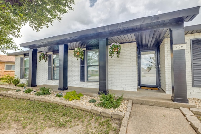 726 W Crossland Blvd, Grand Prairie, TX 75052 - view of exterior entry with brick siding and covered porch