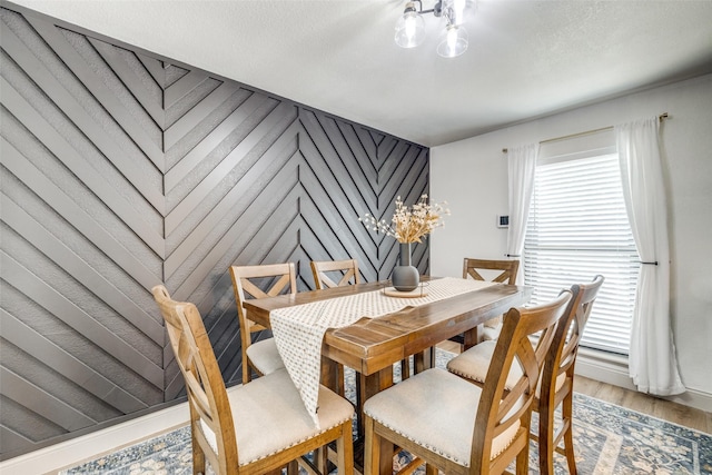 726 W Crossland Blvd, Grand Prairie, TX 75052 - dining room with a chandelier, light wood-type flooring, and an accent wall
