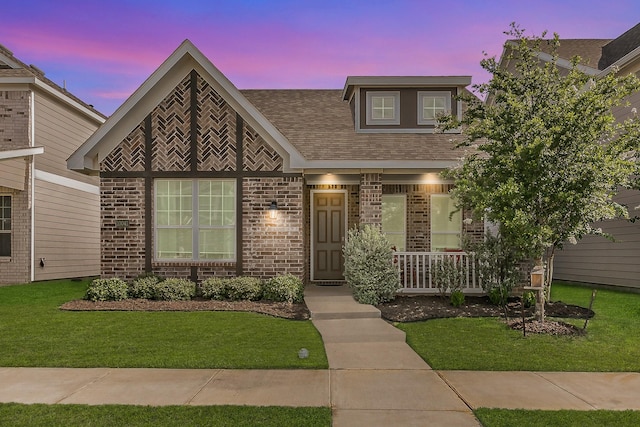 10041 Adams Ln, Providence Village, TX 76227 - view of front of home featuring brick siding, a porch, a lawn, and a shingled roof
