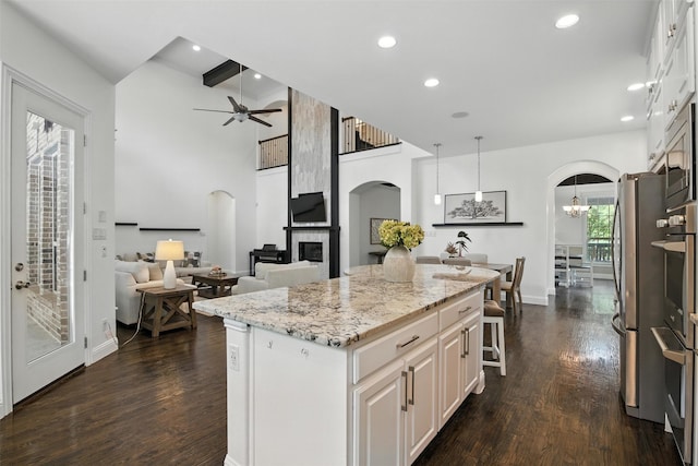 9601 Blackpine Ct, Argyle, TX 76226 - kitchen featuring arched walkways, a ceiling fan, dark wood-style floors, and recessed lighting