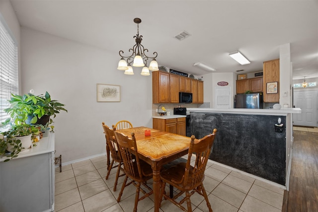 708 Hummingbird Trl, Crowley, TX 76036 - dining area with a chandelier and light tile patterned flooring