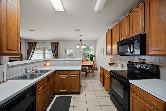 708 Hummingbird Trl, Crowley, TX 76036 - kitchen with black appliances, brown cabinets, and decorative backsplash