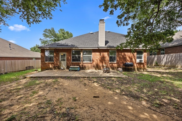 708 Hummingbird Trl, Crowley, TX 76036 - back of house featuring a patio, a fenced backyard, a chimney, roof with shingles, and brick siding