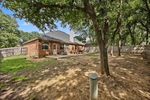 708 Hummingbird Trl, Crowley, TX 76036 - back of house featuring a chimney, a fenced backyard, and a patio