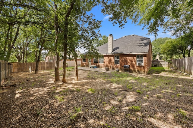708 Hummingbird Trl, Crowley, TX 76036 - rear view of property featuring a chimney, a patio, a fenced backyard, and a shingled roof