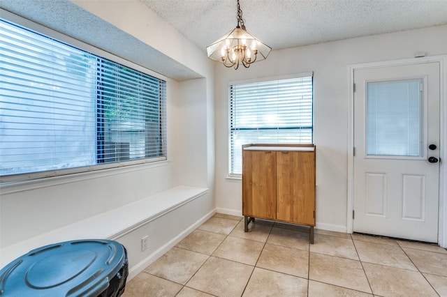 6720 Cedar Forest Trl, Dallas, TX 75236 - unfurnished dining area with a chandelier, light tile patterned floors, and a textured ceiling