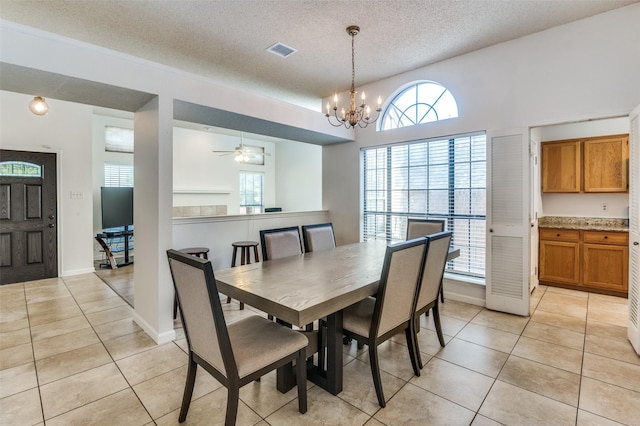 6720 Cedar Forest Trl, Dallas, TX 75236 - dining space featuring light tile patterned floors, a textured ceiling, a chandelier, and plenty of natural light
