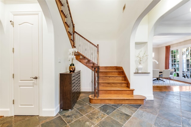 3517 Haynie Ave, University Park, TX 75205 - stairway with arched walkways, stone tile floors, and ornamental molding