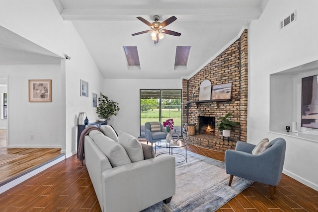 3509 Ames Rd, Lancaster, TX 75134 - living area featuring ceiling fan, wood tiled floors, a brick fireplace, high vaulted ceiling, and a skylight