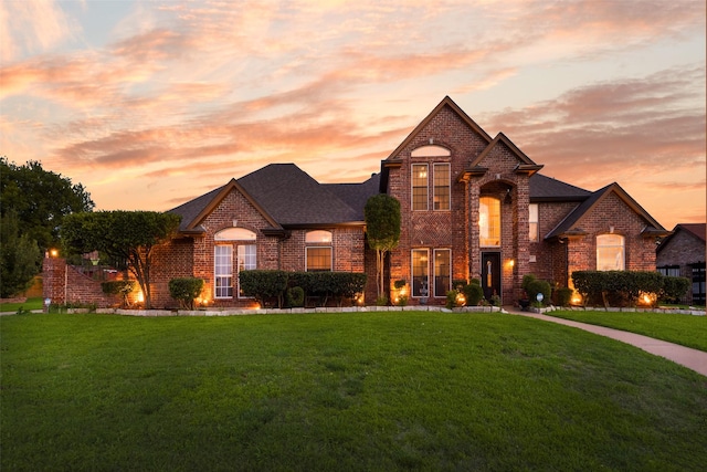 537 Estate Dr, Grand Prairie, TX 75052 - french country inspired facade with brick siding, a lawn, and roof with shingles